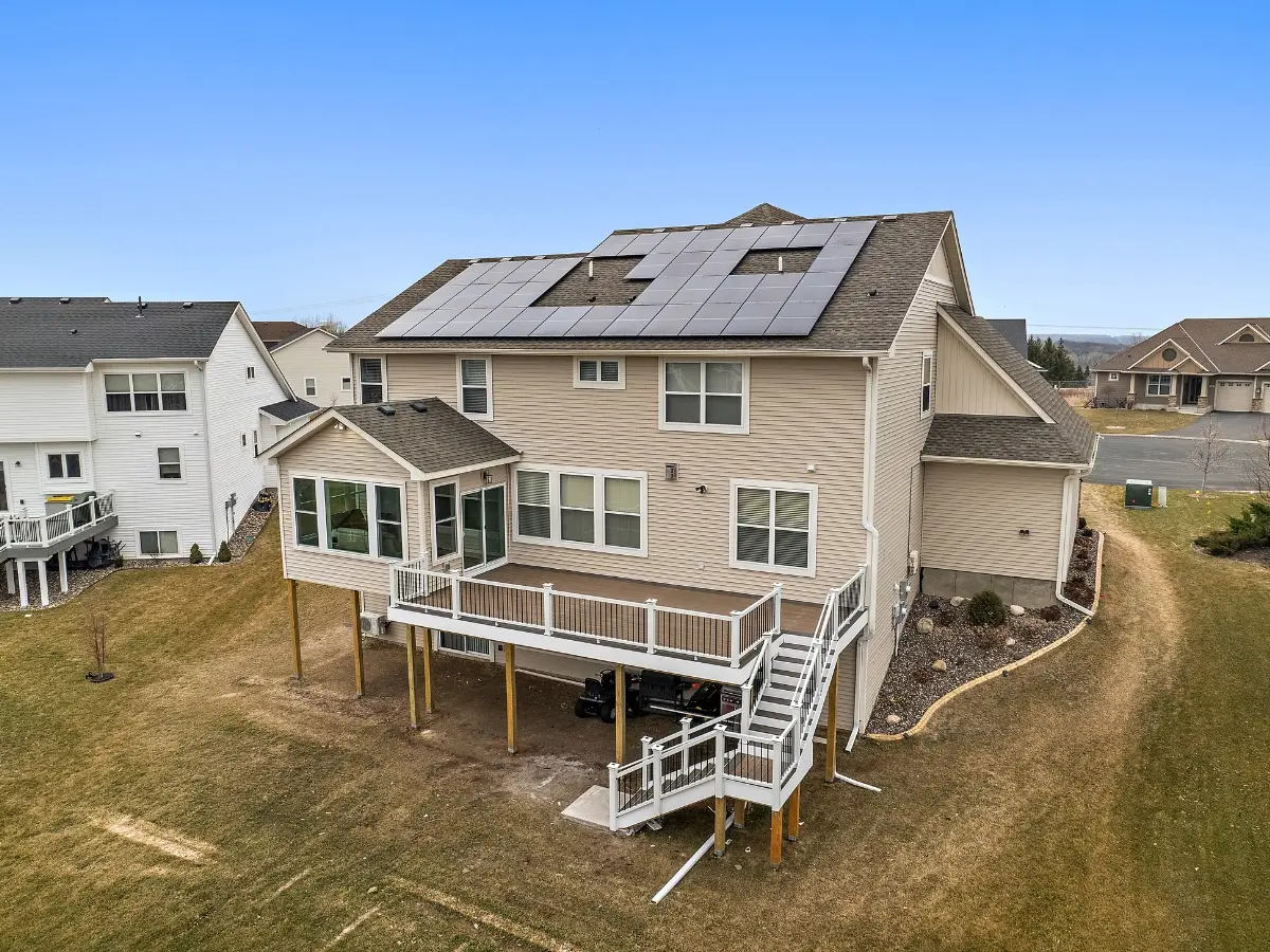 A modern new‑construction home’s front exterior at a clean angle in the Minneapolis, MN area — captured by UAV Vision Media (Chris Blaeser), evoking architectural precision, fresh design, and striking curb appeal.
