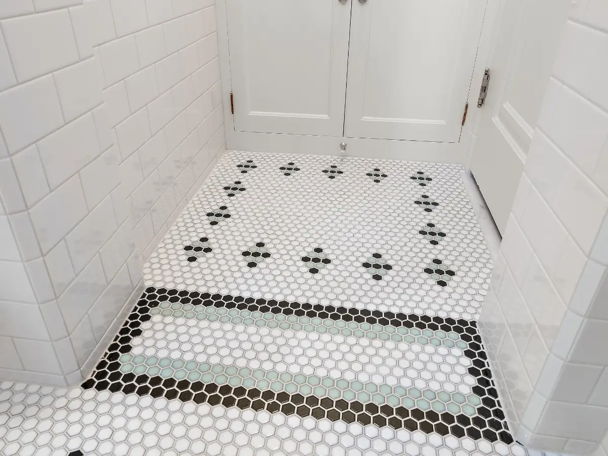 Close-up perspective of a tile floor and shower entrance in a Hopkins, Minnesota bathroom remodel, highlighting craftsmanship, clean lines, and modern design—photographed by Chris Blaeser of UAV Vision Media, a trusted local Native American photography company